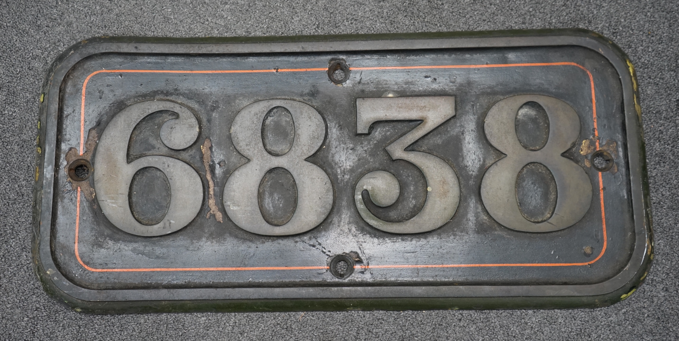 A cast iron GWR locomotive cab side number plate for a Grange Class 4-6-0 tender locomotive, Goodmoor Grange 6838, built in September 1937 and withdrawn by BR in November 1965, dimensions; 64cm x 30cm. Condition - fair,